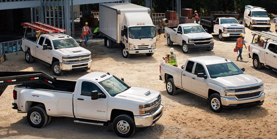 Fleet of pick-up trucks at job site